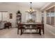 Bright dining room with large windows and stylish chandelier lighting, featuring a dining table at 11543 W Sandsnake Ct, Surprise, AZ 85378