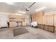 Spacious garage with wall-mounted cabinets, workbench area, and ample room for vehicles and storage at 11543 W Sandsnake Ct, Surprise, AZ 85378