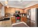 Bright kitchen with granite countertops, stainless steel appliances, and wood cabinetry at 11543 W Sandsnake Ct, Surprise, AZ 85378