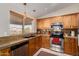 Well-lit kitchen featuring granite countertops and stainless steel appliances, with wooden cabinets at 11543 W Sandsnake Ct, Surprise, AZ 85378