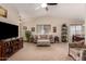 Inviting living room featuring vaulted ceilings, with a ceiling fan and view of dining area at 11543 W Sandsnake Ct, Surprise, AZ 85378