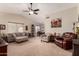 Spacious living room featuring vaulted ceilings and stylish furnishings, with a ceiling fan at 11543 W Sandsnake Ct, Surprise, AZ 85378