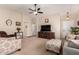 Bright and airy living room featuring a ceiling fan, comfortable furnishings, and neutral tones at 11543 W Sandsnake Ct, Surprise, AZ 85378