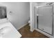 Bathroom featuring glass enclosed shower, white countertop sink, and tiled flooring at 13335 W Marlette Ct, Litchfield Park, AZ 85340