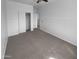 A carpeted bedroom features an open closet and neutral walls, offering a versatile space at 13335 W Marlette Ct, Litchfield Park, AZ 85340