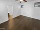 A bright bedroom with hardwood floors features a ceiling fan and ensuite bathroom access at 13335 W Marlette Ct, Litchfield Park, AZ 85340