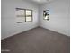 Empty bedroom with neutral carpet and freshly painted white walls, with a window view at 13335 W Marlette Ct, Litchfield Park, AZ 85340