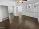 Spacious bedroom with hardwood flooring, large window, and mirrored closet doors at 13335 W Marlette Ct, Litchfield Park, AZ 85340