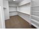 Walk-in closet with built-in shelving and ample storage space at 13335 W Marlette Ct, Litchfield Park, AZ 85340
