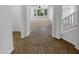 Tiled entryway leading to a carpeted living area with bright light at 13335 W Marlette Ct, Litchfield Park, AZ 85340