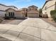 Two-story home featuring desert landscaping and a spacious driveway leading to a three-car garage at 13335 W Marlette Ct, Litchfield Park, AZ 85340