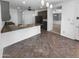 Open kitchen boasts a large breakfast bar, stainless steel appliances, and a tile floor at 13335 W Marlette Ct, Litchfield Park, AZ 85340