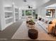 Bright living room featuring recessed lighting, built-in shelving, neutral furniture, and backyard views at 13335 W Marlette Ct, Litchfield Park, AZ 85340