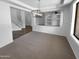 An open-concept living room features carpet flooring, modern lighting, and a staircase leading to the upper level at 13335 W Marlette Ct, Litchfield Park, AZ 85340