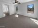 The primary bedroom includes carpet, ceiling fan, and dual windows for natural light at 13335 W Marlette Ct, Litchfield Park, AZ 85340