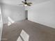 Spacious carpeted primary bedroom with ceiling fan and interior doors at 13335 W Marlette Ct, Litchfield Park, AZ 85340