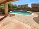 Backyard pool and spa area with desert landscaping and tiled patio, perfect for relaxing at 13335 W Marlette Ct, Litchfield Park, AZ 85340
