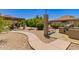 Inviting common area with grill, bench, shaded seating, and a serene walkway surrounded by lush landscaping at 1402 E Guadalupe Rd # 234, Tempe, AZ 85283