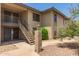 Tan apartment building featuring exterior stairs and desert landscaping at 1402 E Guadalupe Rd # 234, Tempe, AZ 85283