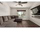 Bright living room featuring dark wood floors, window and comfortable gray couch at 1402 E Guadalupe Rd # 234, Tempe, AZ 85283