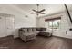 Living room with dark wood floors, large window, and comfortable gray couch at 1402 E Guadalupe Rd # 234, Tempe, AZ 85283