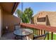 Outdoor balcony with table and chairs, with lush greenery and building views at 14203 N 19Th Ave # 2036, Phoenix, AZ 85023