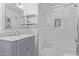 Bathroom featuring marble tiled shower and updated vanity with chrome faucet at 14203 N 19Th Ave # 2036, Phoenix, AZ 85023
