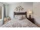 Cozy bedroom with decorative tree art piece above the dark wood headboard at 14203 N 19Th Ave # 2036, Phoenix, AZ 85023