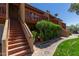 Charming condo exterior featuring wood railings, desert landscaping, and a well-maintained walkway at 14203 N 19Th Ave # 2036, Phoenix, AZ 85023