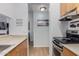 Galley-style kitchen featuring wood cabinets, stainless steel appliances, and sleek countertops at 14203 N 19Th Ave # 2036, Phoenix, AZ 85023