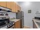 Functional kitchen with stainless steel appliances, light wood cabinetry and ample counter space at 14203 N 19Th Ave # 2036, Phoenix, AZ 85023