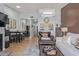 Open-concept living space featuring stylish furniture, wood flooring, and easy access to the dining area at 14203 N 19Th Ave # 2036, Phoenix, AZ 85023