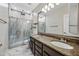 Bathroom featuring a walk-in shower and double sink vanity at 14717 N 97Th Pl, Scottsdale, AZ 85260