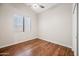 Bedroom with wood flooring, neutral walls, and a ceiling fan at 14717 N 97Th Pl, Scottsdale, AZ 85260