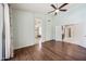 Open bedroom with wood floors and a bathroom with a glass shower at 14717 N 97Th Pl, Scottsdale, AZ 85260