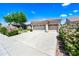 A well-maintained home featuring a two-car garage, desert landscaping, and a sunny desert community setting at 14717 N 97Th Pl, Scottsdale, AZ 85260