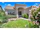 Charming front yard featuring green grass, desert landscaping, and a well-maintained facade in a sunny neighborhood at 14717 N 97Th Pl, Scottsdale, AZ 85260
