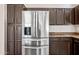 This kitchen features stainless steel fridge, custom cabinets, and granite countertops at 14717 N 97Th Pl, Scottsdale, AZ 85260