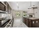 Gourmet kitchen featuring granite counters, kitchen island, stainless steel appliances, and custom cabinetry at 14717 N 97Th Pl, Scottsdale, AZ 85260