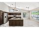 Beautiful kitchen with dark wood cabinets, stainless appliances, and a large island at 14717 N 97Th Pl, Scottsdale, AZ 85260