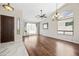 Open living room with hardwood floors, vaulted ceilings, and natural light flowing in from large window at 14717 N 97Th Pl, Scottsdale, AZ 85260