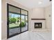 Bright living room features a fireplace and sliding glass doors opening to the lush backyard at 14717 N 97Th Pl, Scottsdale, AZ 85260