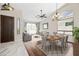 Staged living room featuring hardwood floors, vaulted ceilings, and natural light flowing in from large window at 14717 N 97Th Pl, Scottsdale, AZ 85260