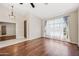 Open living room with hardwood floors, vaulted ceilings, and natural light flowing in from large window at 14717 N 97Th Pl, Scottsdale, AZ 85260