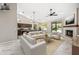 Staged living space featuring a kitchen, living room, and fireplace at 14717 N 97Th Pl, Scottsdale, AZ 85260
