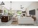 A beautifully staged living space showcasing an open floor plan with kitchen and fireplace at 14717 N 97Th Pl, Scottsdale, AZ 85260