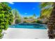 Refreshing pool with vibrant blue tile and sparkling water, complemented by lush greenery and a bright, sunny atmosphere at 14717 N 97Th Pl, Scottsdale, AZ 85260