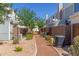 Well maintained backyard path with colorful flowers, shrubs, and air conditioning units at 1600 N Saba St # 143, Chandler, AZ 85225