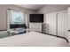 Bedroom features large window, TV, and closet to maximize space at 1600 N Saba St # 143, Chandler, AZ 85225