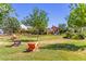 Beautifully landscaped common area with Adirondack seating and mature trees at 1600 N Saba St # 143, Chandler, AZ 85225